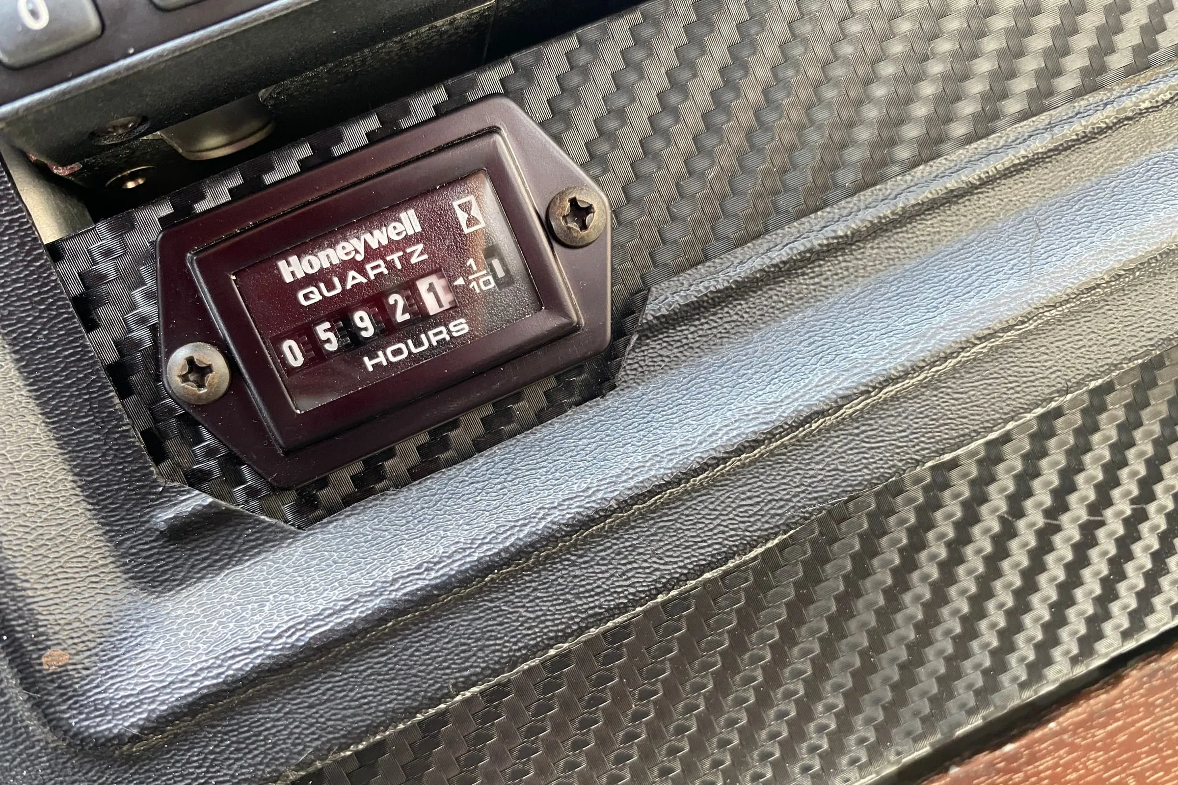 An hour meter set into a cockpit panel, reading 592.1 hours